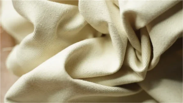 Wrinkled cream-colored fabric close-up
