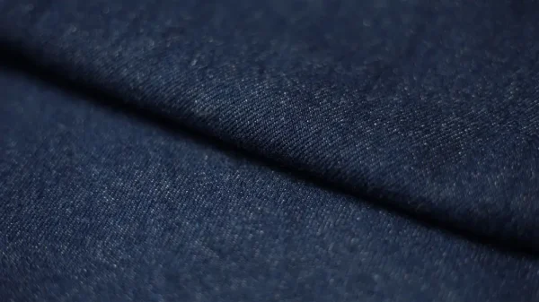 Close-up of dark denim fabric.